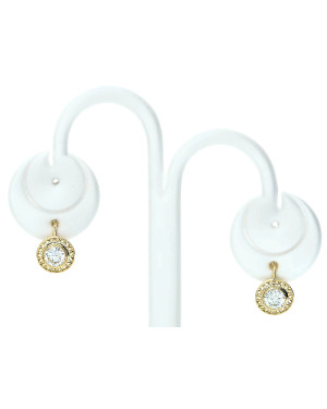 Lacy gold earrings with a white stone
