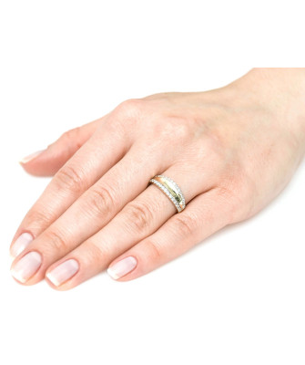 Wide gold ring like a wedding band with cubic zirconia