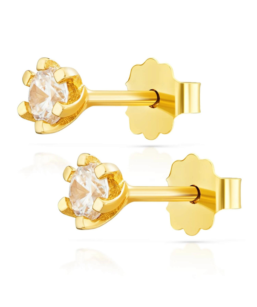 Delicate gold earrings with a white stone