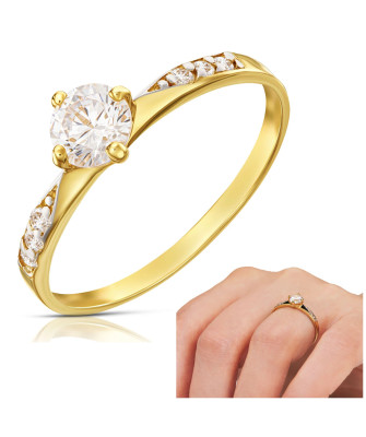 Gold engagement ring with a white stone