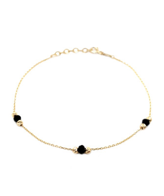 Bracelet with six golden diamond-cut beads and three black stones