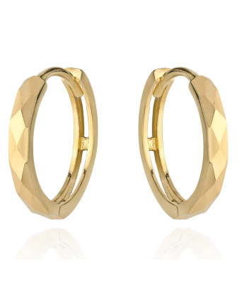 Gold diamond-cut hoop earrings on a creole