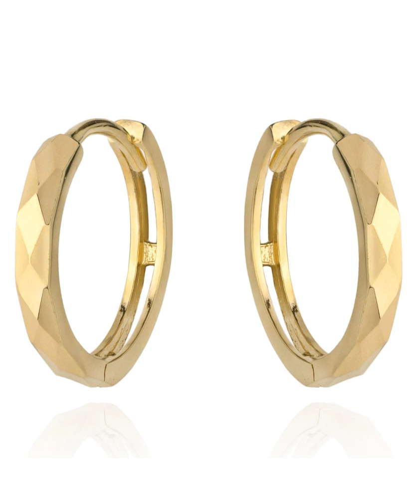 Gold diamond-cut hoop earrings on a creole