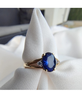 Gold ring with a sapphire central stone.