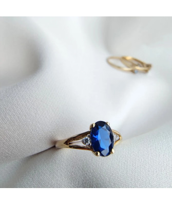 Gold ring with a sapphire central stone.