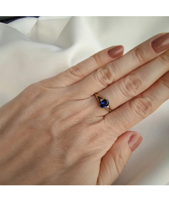 Gold ring with a sapphire central stone.
