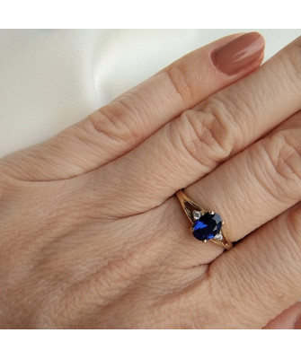 Gold ring with a sapphire central stone.