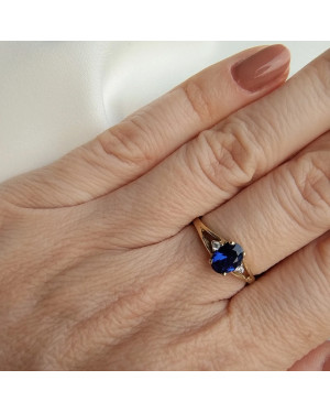 Gold ring with a sapphire central stone.