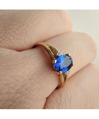 Gold ring with a sapphire central stone.