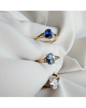 Gold ring with a sapphire central stone.