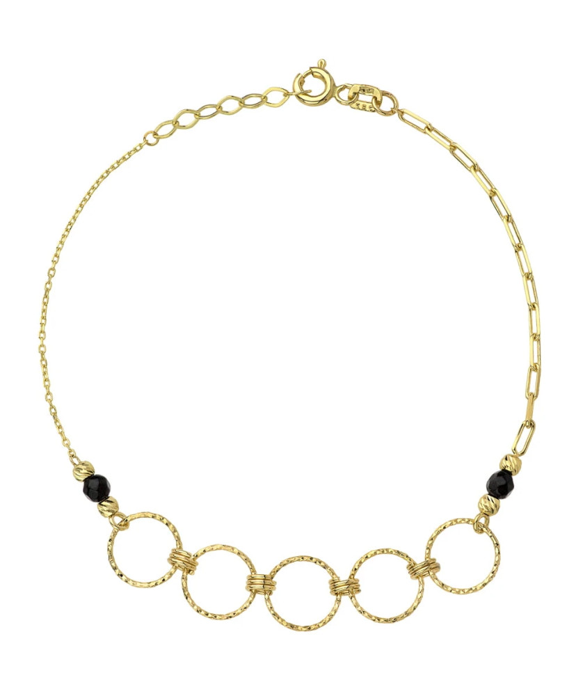 Gold diamond-cut rings and black stones bracelet
