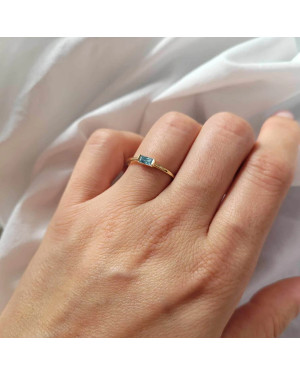 Delicate gold ring with a light blue stone