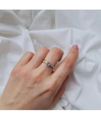 Gold engagement ring blue stone