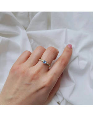 Gold engagement ring blue stone