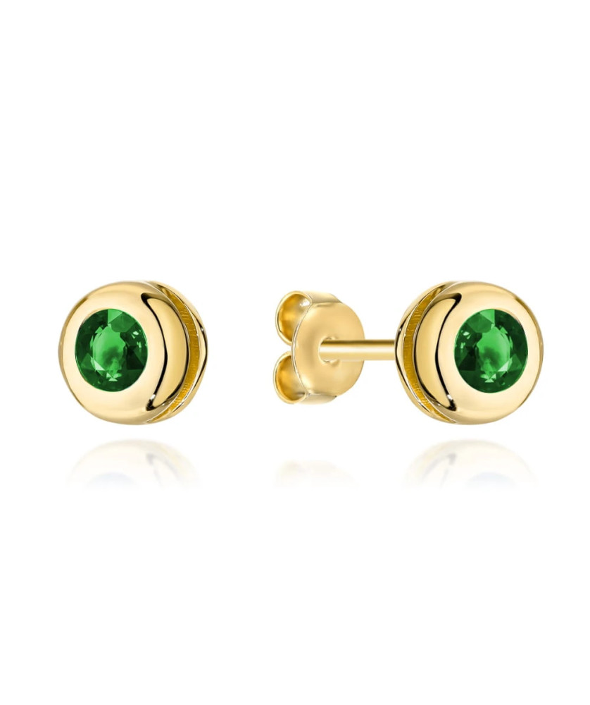 Gold earrings with a green stone surrounded by gold