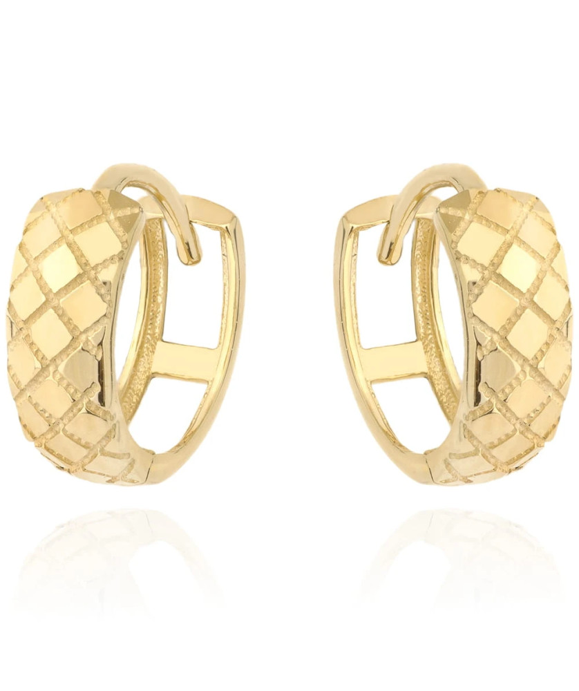 Gold earrings delicately decorated on a hoop
