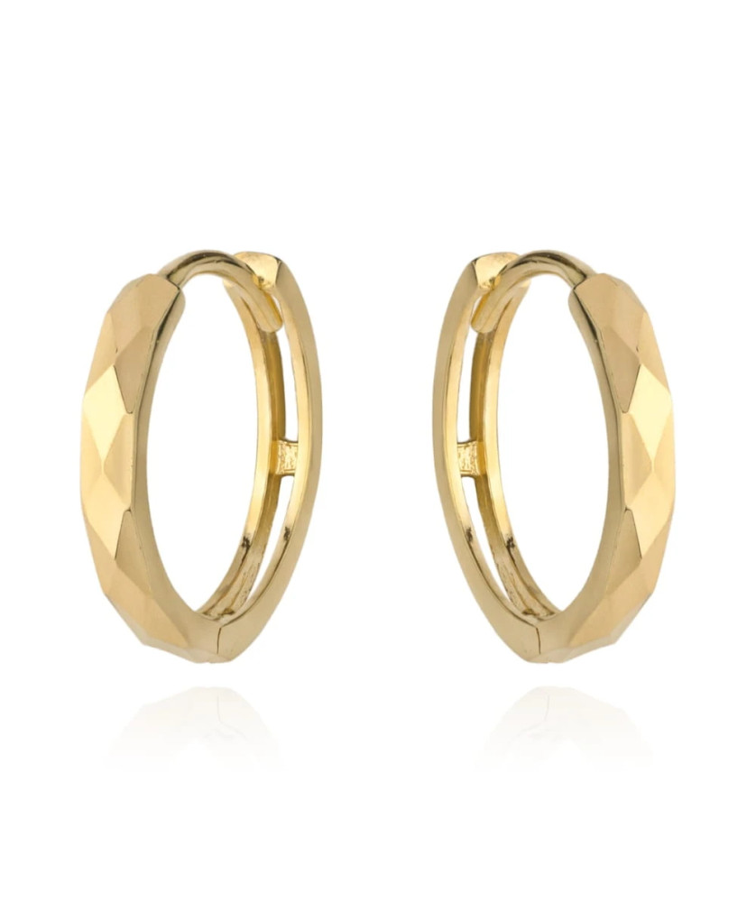 Gold diamond-cut hoop earrings on creole