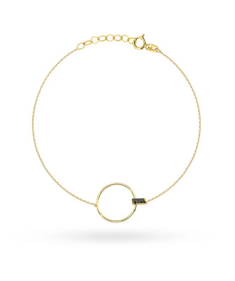 Gold circle bracelet and black stone in a rectangle