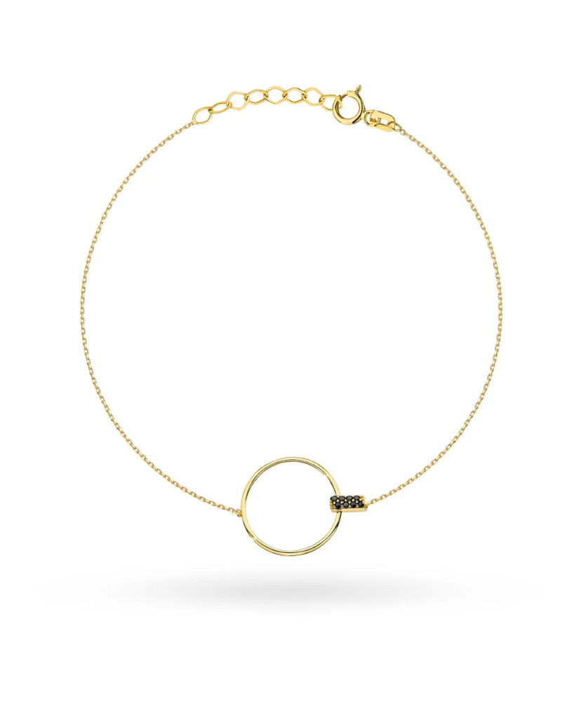 Gold circle bracelet and black stone in a rectangle