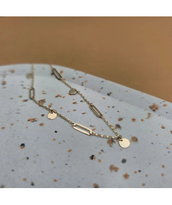 Gold bracelet with links and solid circles