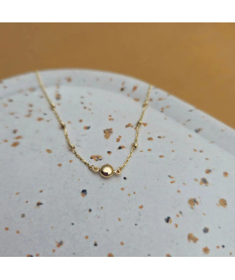 Gold bracelet with a circle and diamond-cut beads