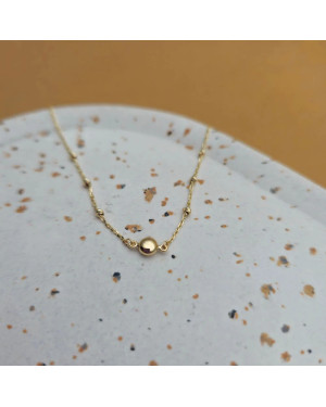 Gold bracelet with a circle and diamond-cut beads