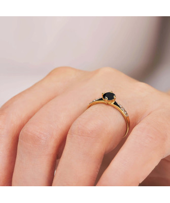 Gold engagement ring with black stone
