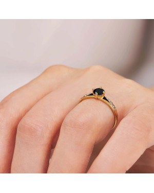 Gold engagement ring with black stone